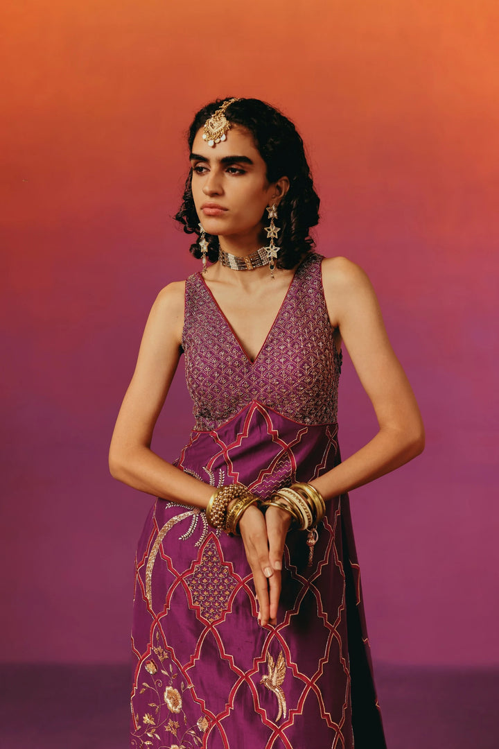 Close-up of the beaded bodice of Warra's wine-purple kurta set with a diamond pattern, worn with a gold mathapatti headpiece, choker and layered bangles