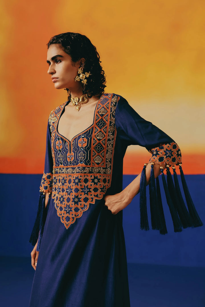 Close-up of Warra's navy silk kaftan with orange-and-gold jaal embroidery on the yoke