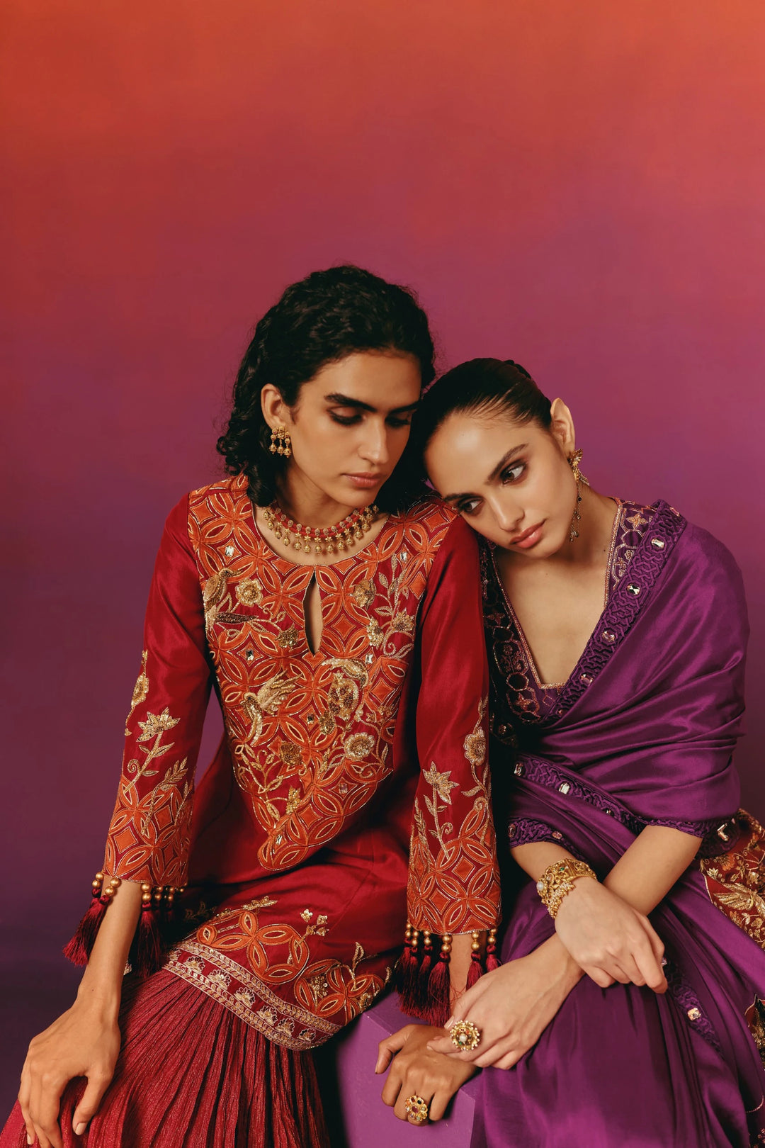 Side profile view of a model in Warra's purple silk saree showing the embroidered mirror-work blouse and the red-and-gold embroidered pallu border trailing behind